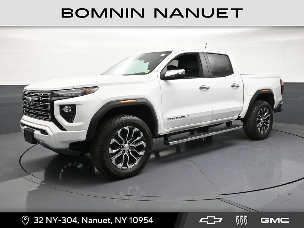 2025 GMC Canyon Denali in Summit White — front three-quarter view